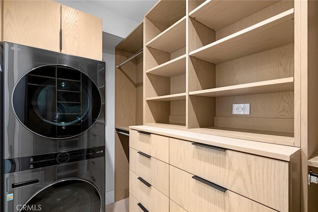 spacious closet with stacked washing maching and dryer