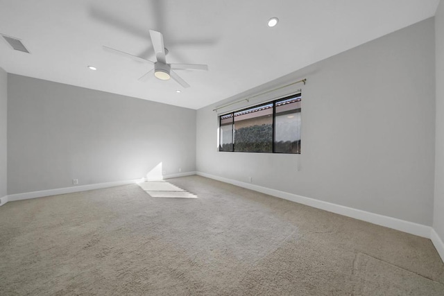 spare room with ceiling fan and carpet