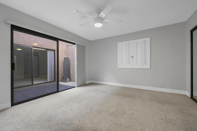 unfurnished room with ceiling fan and carpet floors