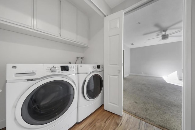 washroom with separate washer and dryer, cabinets, light hardwood / wood-style flooring, and ceiling fan