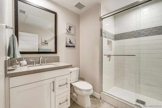 bathroom featuring walk in shower, vanity, toilet, and tile patterned flooring