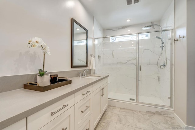 bathroom featuring vanity and an enclosed shower