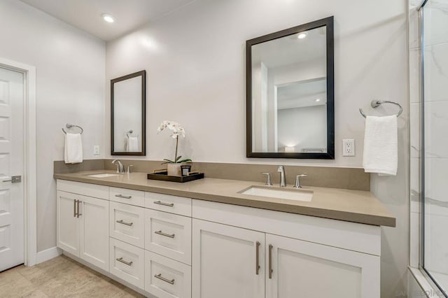 bathroom featuring a shower with door and vanity