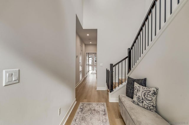 entrance foyer with a towering ceiling and light wood-type flooring