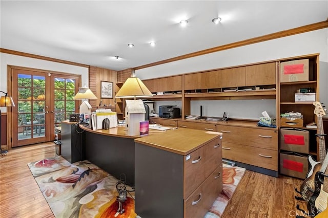 office area with light hardwood / wood-style floors, ornamental molding, and french doors