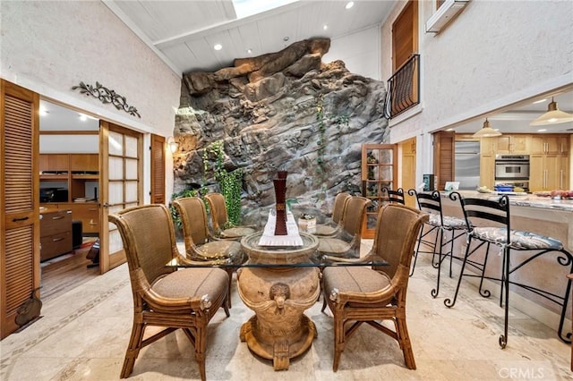 dining space with a high ceiling