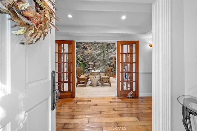 doorway with french doors and light wood-type flooring