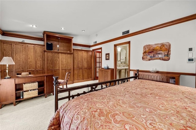 carpeted bedroom featuring ensuite bathroom