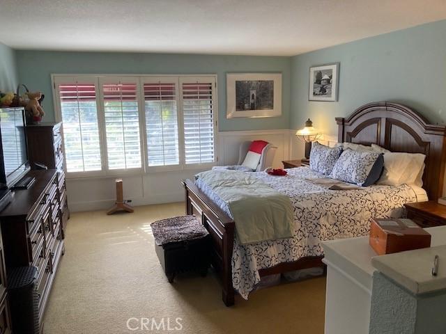 bedroom featuring light carpet