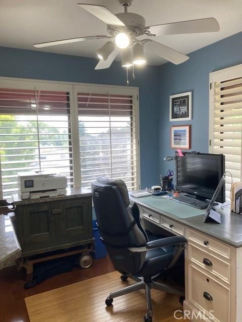 office with hardwood / wood-style flooring and ceiling fan