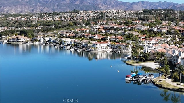 birds eye view of property with a water and mountain view