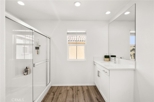 bathroom with vanity, wood-type flooring, and a shower with shower door