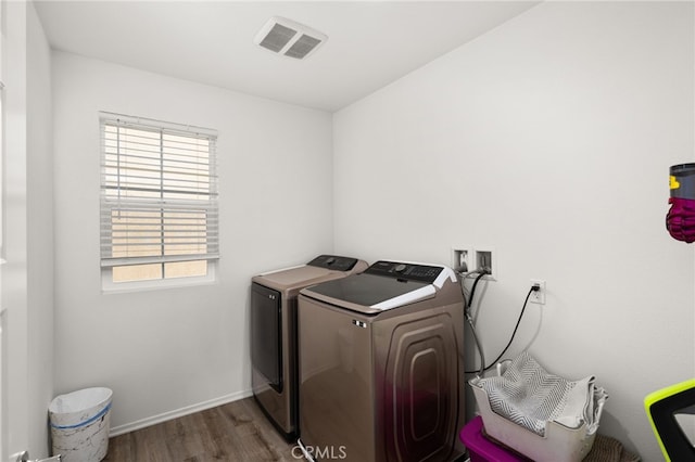 laundry room with dark hardwood / wood-style flooring and washing machine and clothes dryer