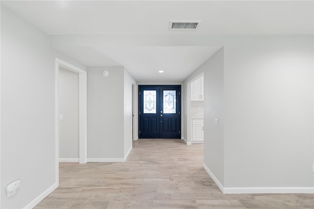 entrance foyer with light wood-type flooring and french doors