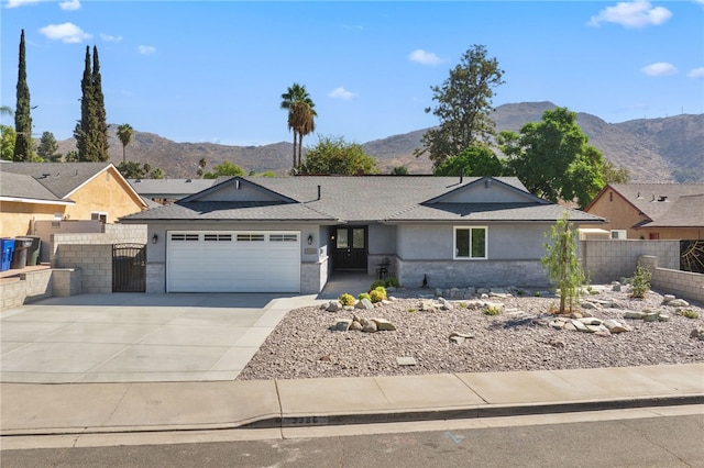 ranch-style house with a garage and a mountain view