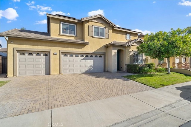 view of front of property featuring a front lawn and a garage