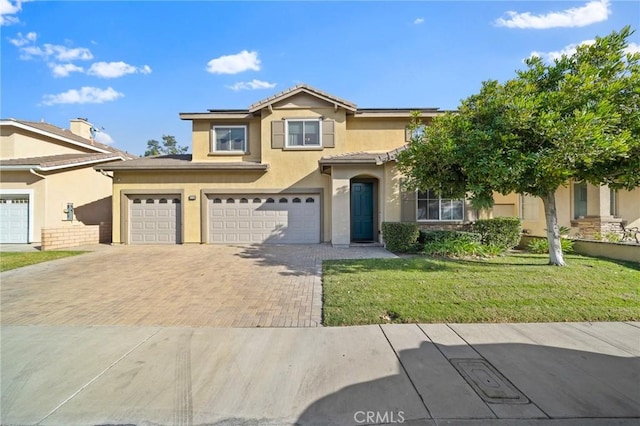 view of front of property with a garage and a front lawn