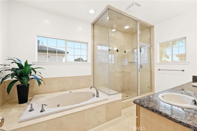 bathroom with vanity and separate shower and tub