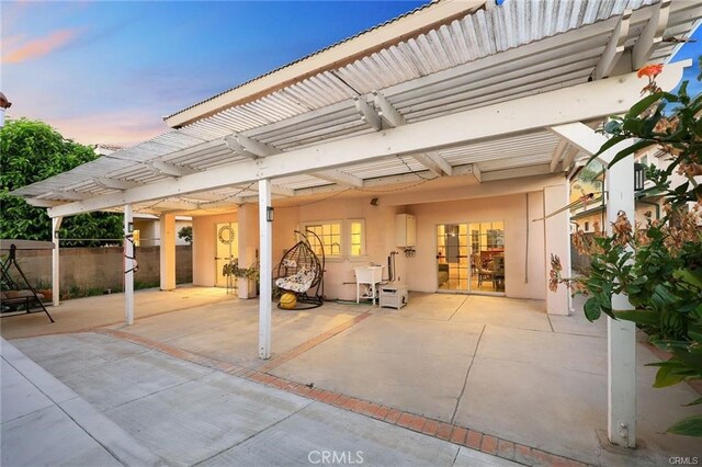 patio terrace at dusk with a pergola