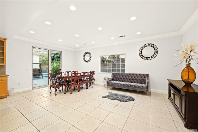 dining room with plenty of natural light, light tile patterned floors, and ornamental molding