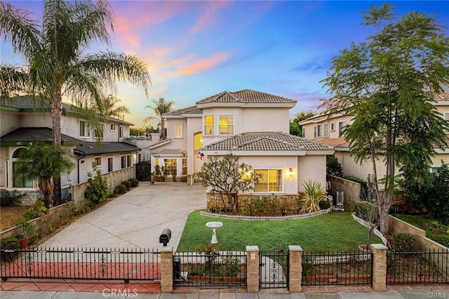 mediterranean / spanish-style house with a lawn