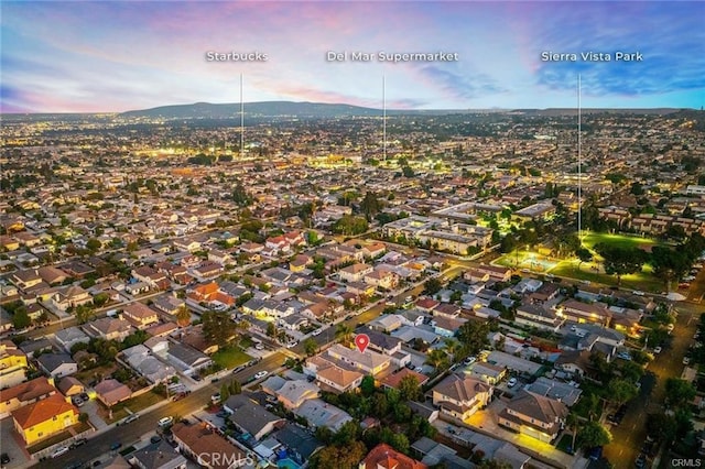 aerial view at dusk featuring a mountain view