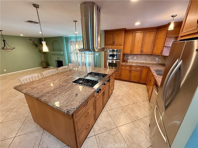 kitchen with a kitchen island, a breakfast bar, island exhaust hood, hanging light fixtures, and stainless steel appliances