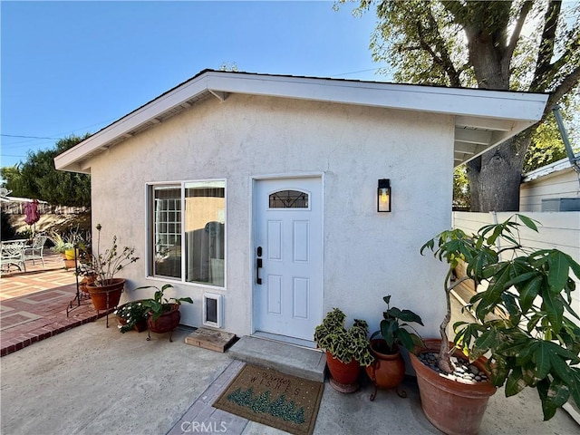 entrance to property with a patio area