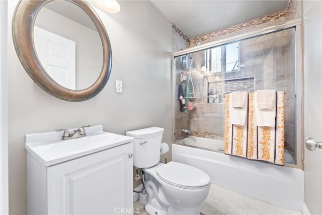 full bathroom featuring toilet, vanity, and shower / bath combination with glass door