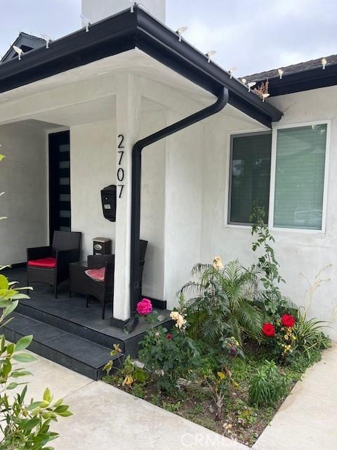 view of side of property with covered porch