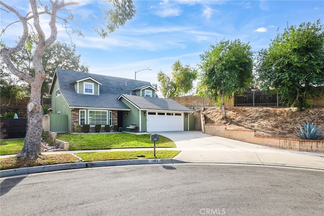 view of front of home with a front yard and a garage