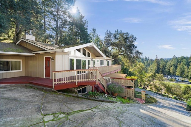 rear view of house featuring a deck