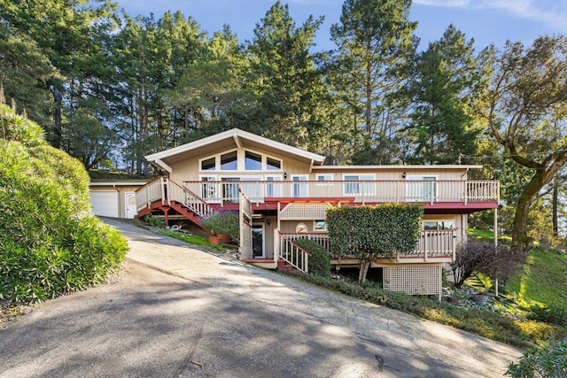 view of front of property featuring a garage and an outdoor structure