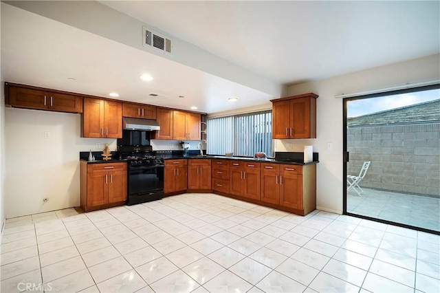 kitchen featuring light tile patterned floors, black gas stove, and sink