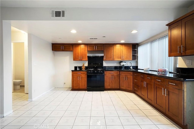 kitchen featuring sink, gas stove, and light tile patterned flooring