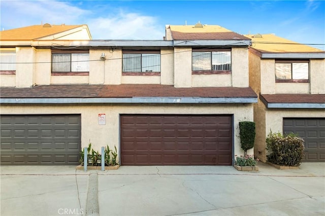 view of property with a garage and a balcony