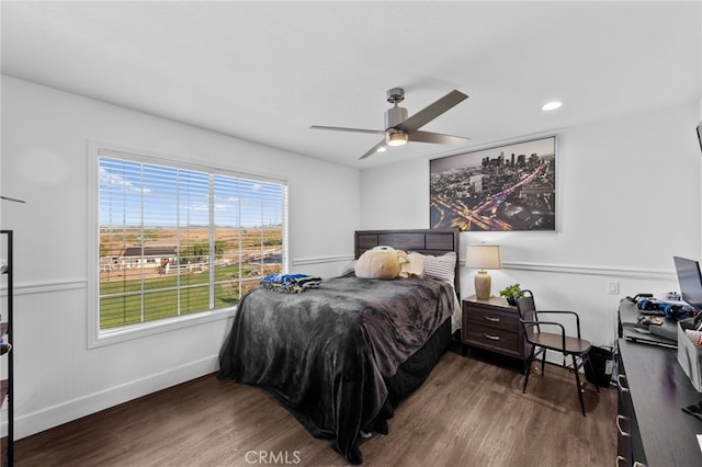 bedroom with ceiling fan and hardwood / wood-style floors