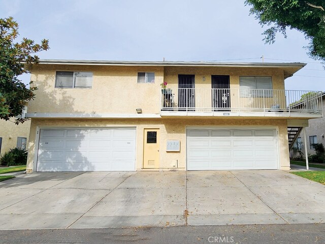 view of front of home featuring a garage and a balcony