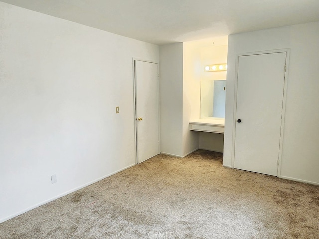 unfurnished bedroom featuring light colored carpet