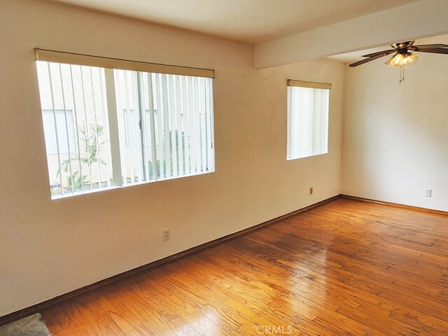 unfurnished room featuring hardwood / wood-style flooring and ceiling fan