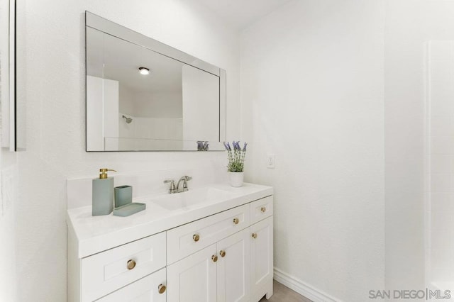 bathroom with walk in shower and vanity