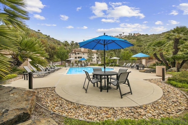 view of swimming pool featuring a patio area and a mountain view