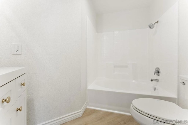 full bathroom with toilet, vanity, shower / bathtub combination, and hardwood / wood-style flooring