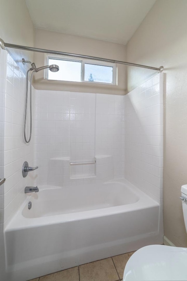 bathroom with bathtub / shower combination, toilet, and tile patterned flooring