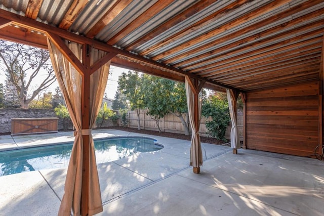 view of pool featuring a patio and a jacuzzi