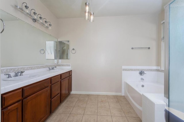 bathroom with vanity, tile patterned floors, and tiled bath