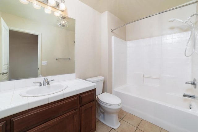 full bathroom with vanity, tile patterned floors, washtub / shower combination, and toilet