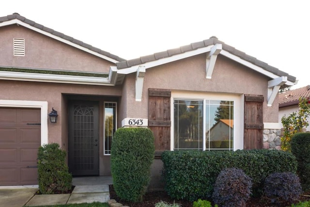 doorway to property featuring a garage