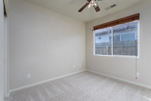 carpeted spare room with ceiling fan