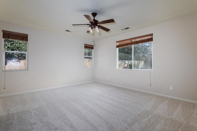 carpeted empty room featuring ceiling fan